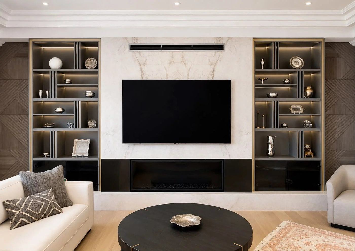 Finished basement media wall with a marble-look TV surround, linear fireplace and lit display shelving in Woodbridge, by NewGen Renovations Vaughan