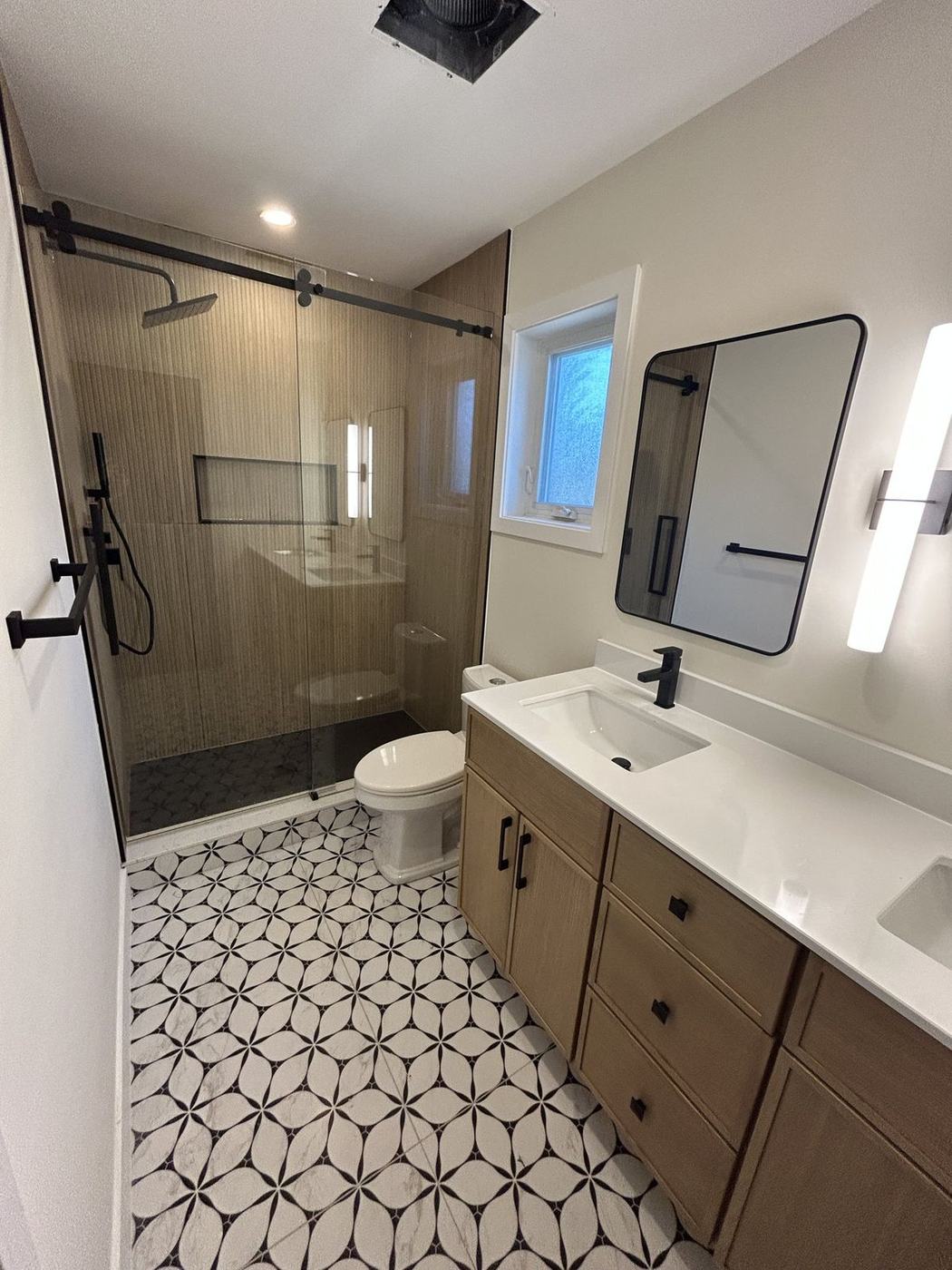Black and white patterned porcelain bathroom floor tile, installed by NewGen Renovations Vaughan